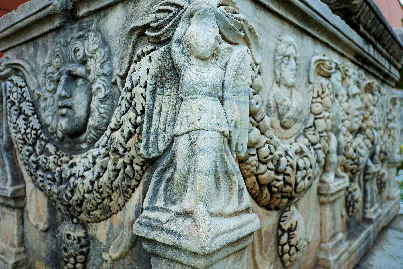 a close up of a statue on a building